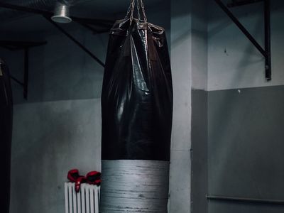 Minimalist gym equipment against a dark wall.